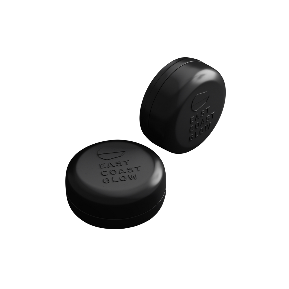 Aluminum travel tin with draining base for storing East Coast Glow solid shampoo or conditioner bars, ideal for travel and daily use. Black