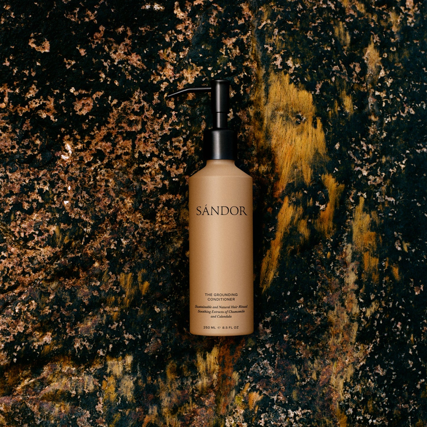SANDOR conditioner bottle on a textured dark background