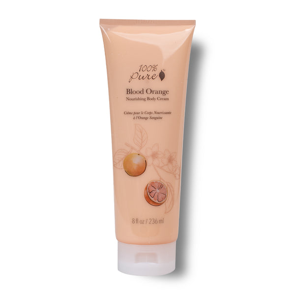 A tube of 100% Pure Blood Orange Nourishing Body Cream on a white background. The tube is a soft peach-pink color with illustrations of an orange and a sliced orange on the front, and a white cap at the bottom.
