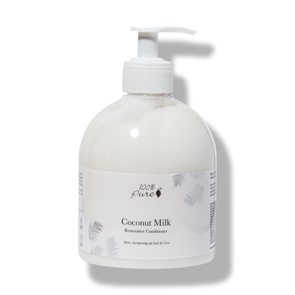 Coconut milk conditioner bottle with pump on a white background