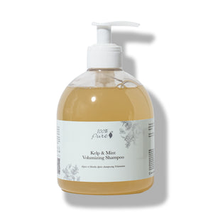 A bottle of 100% Pure Kelp & Mint Volumizing Shampoo with a white pump dispenser, containing a golden-amber liquid, set against a plain white background with a soft shadow.