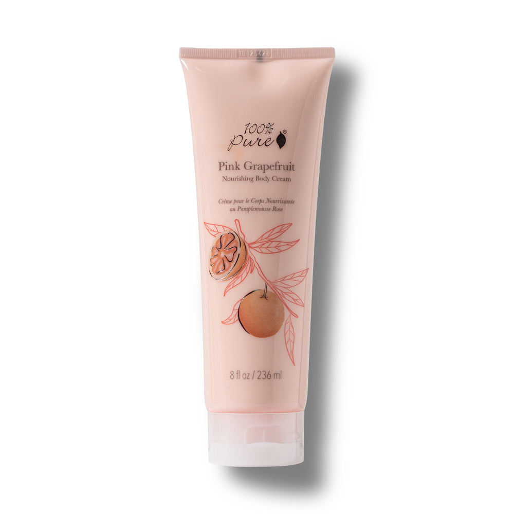 A single tube of 100% Pure Pink Grapefruit Nourishing Body Cream on a white background with a soft drop shadow. The tube is a pale pink color with illustrations of a grapefruit and pink leaves, and black text detailing the product name and brand.