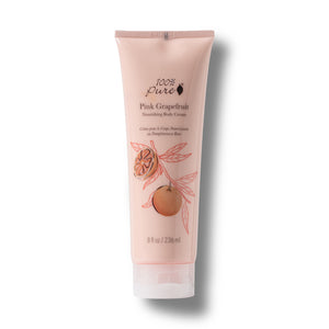 A single tube of 100% Pure Pink Grapefruit Nourishing Body Cream on a white background with a soft drop shadow. The tube is a pale pink color with illustrations of a grapefruit and pink leaves, and black text detailing the product name and brand.