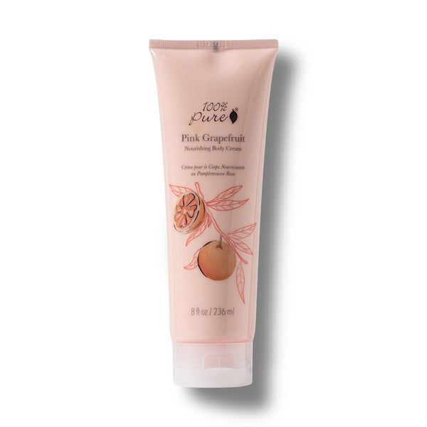 A single tube of 100% Pure Pink Grapefruit Nourishing Body Cream on a white background with a soft drop shadow. The tube is a pale pink color with illustrations of a grapefruit and pink leaves, and black text detailing the product name and brand.