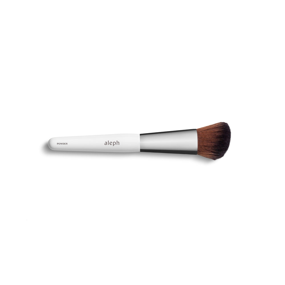 ALEPH Powder Brush with angled vegan bristles for precise powder application.