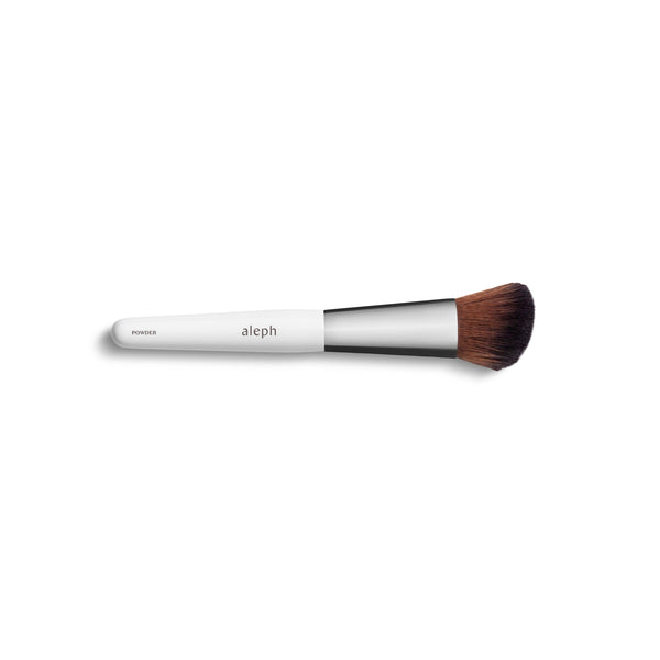 ALEPH Powder Brush with angled vegan bristles for precise powder application.