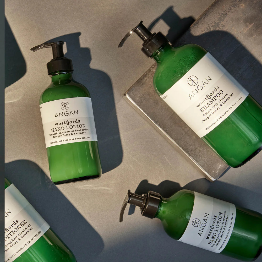 ANGAN Westfjords Hand Lotion in a glass bottle, featuring shea butter, rosehip oil, and aloe vera for nourishment, hydration, and a soft, smooth feel. The natural aroma evokes the serene essence of Iceland’s Westfjords.