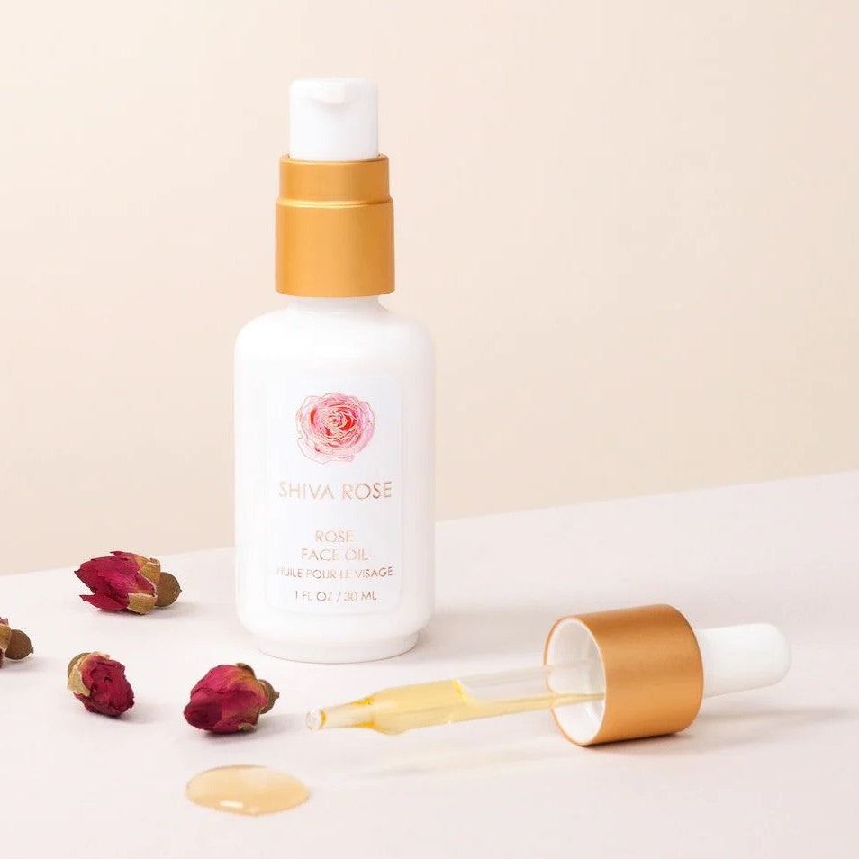Hand-blended SHIVA ROSE Rose Face Oil with organic oils for skin nourishment, featuring key ingredients like jojoba and rosehip seed oil.