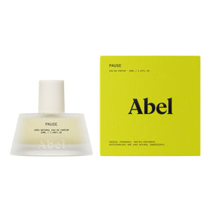Abel Pause Eau de Parfum bottle next to its lime green packaging box on a white background.