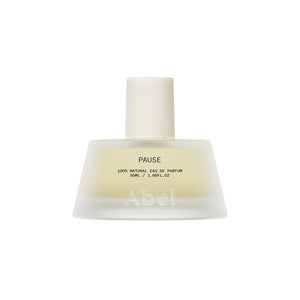 A frosted glass perfume bottle with a matte white cap, containing a pale yellow liquid. The bottle features the brand name 'Abel' and the fragrance name 'PAUSE' printed on the front, set against a solid white background.