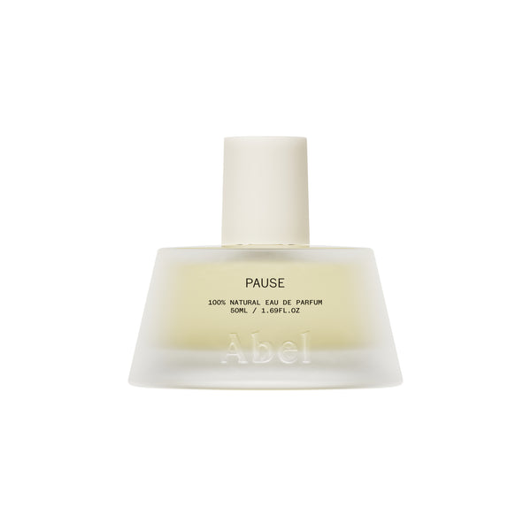 A frosted glass perfume bottle with a matte white cap, containing a pale yellow liquid. The bottle features the brand name 'Abel' and the fragrance name 'PAUSE' printed on the front, set against a solid white background.