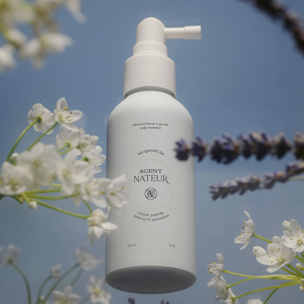 AGENT NATEUR holi (growth) 84 leave-in scalp spray in a sleek white bottle, designed to nourish the scalp and enhance the look of hair density.