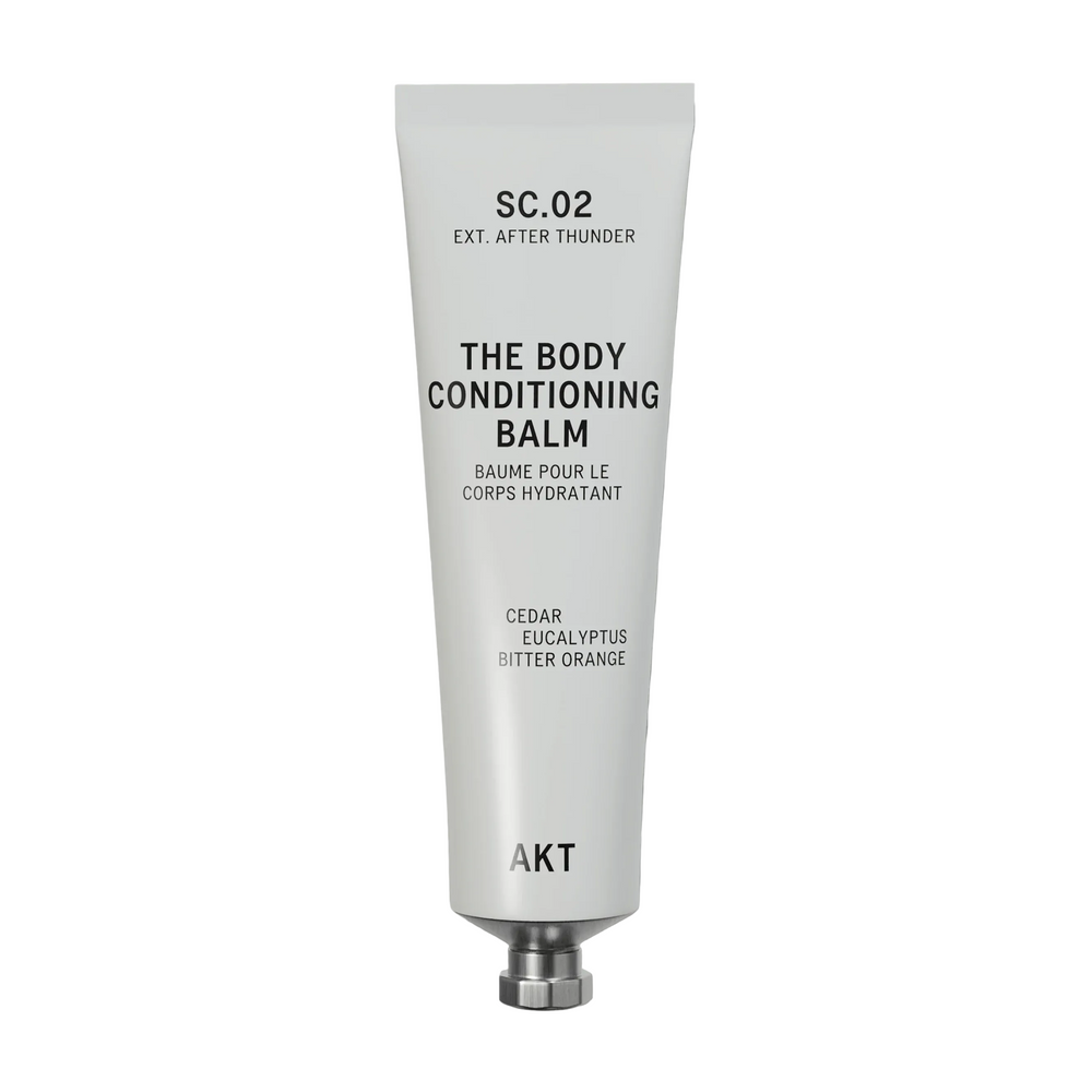 A white squeeze tube of AKT London The Body Conditioning Balm, scent SC.02 After Thunder, with black text on a clean white background.