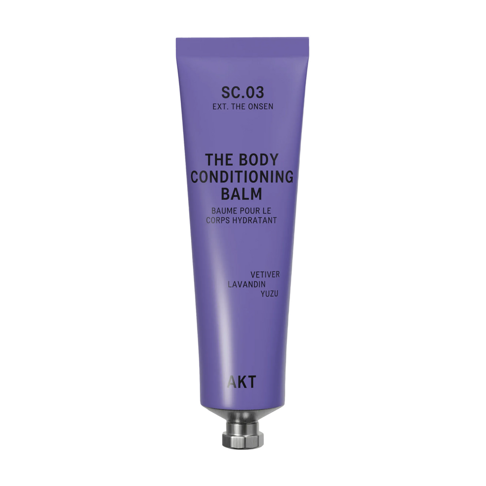 A lavender purple squeeze tube of AKT London The Body Conditioning Balm (SC.03 the Onsen) with a silver metal cap, centered on a light off-white background with a soft shadow.