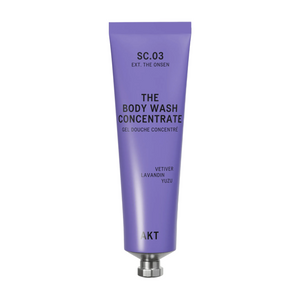 A lavender purple squeeze tube of AKT London The Body Wash Concentrate (SC.03) with a silver metal cap, centered on a clean off-white background.