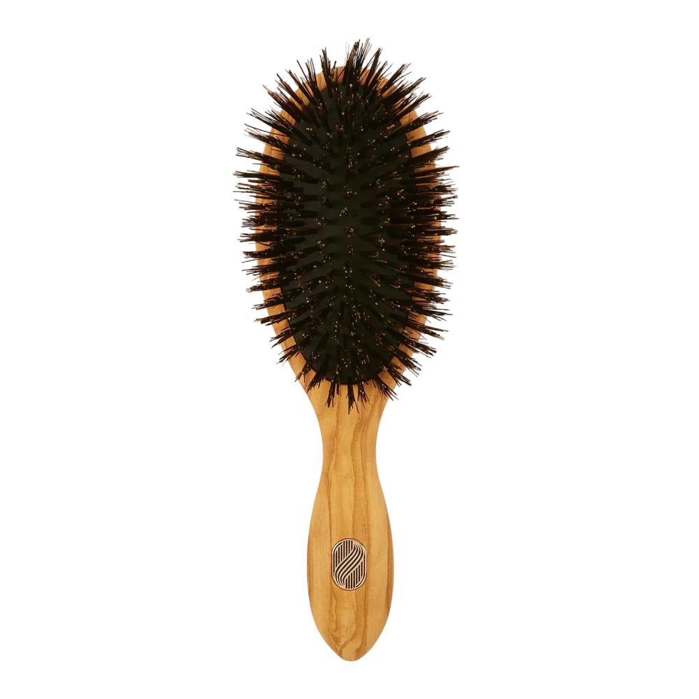 Wooden hairbrush with bristles on a white background