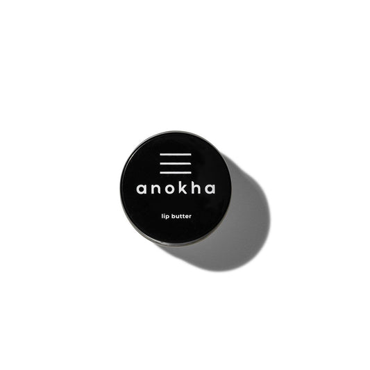 ANOKHA Lip Butter in a small jar, showcasing its creamy texture and organic ingredients, ideal for hydrating and nourishing delicate lips.