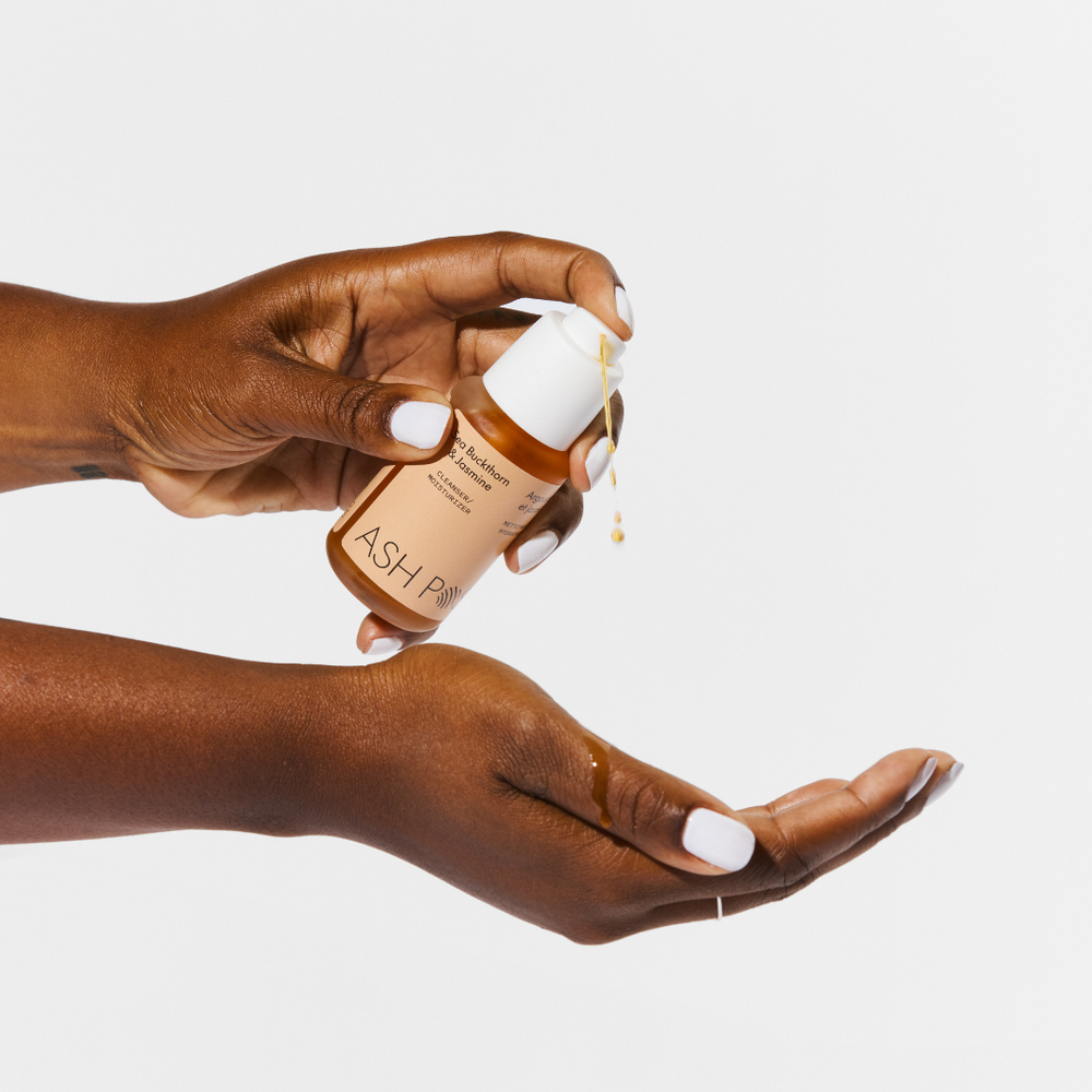 ASH POSY Sea Buckthorn & Jasmine Cleanser/Moisturizer – natural skincare oil in a glass pump bottle with vibrant botanical ingredients.