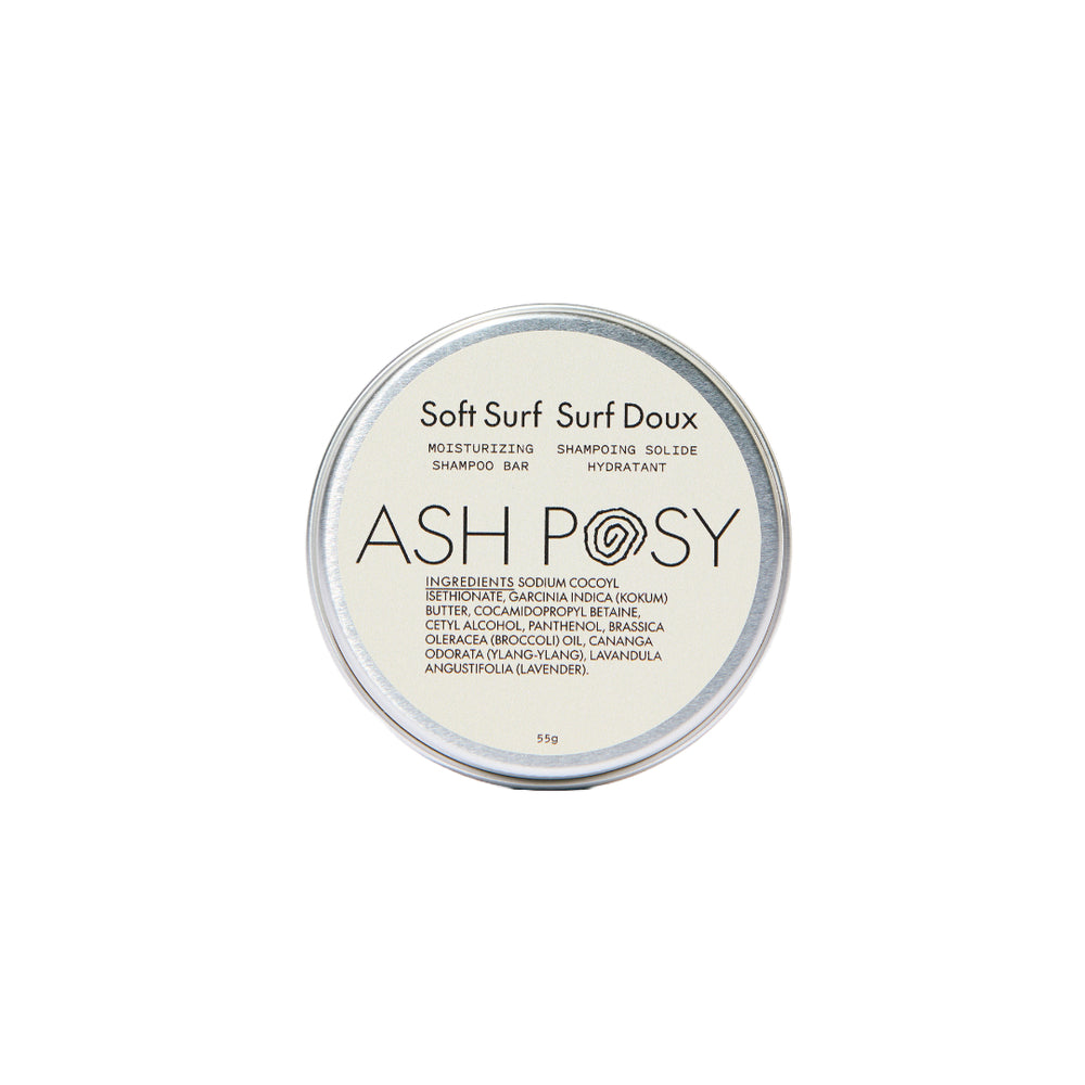 ASH POSY Soft Surf Moisturizing Shampoo Bar – solid shampoo bar with lightweight lathering formula, featuring broccoli seed oil and ylang-ylang, shown with eco-friendly tin.
