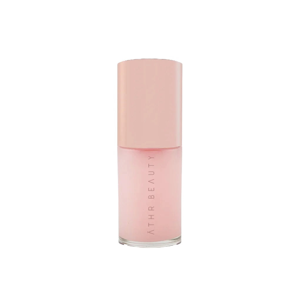 ATHR Beauty Aurora Glow Lip Oil in a sleek bottle, showcasing a luxurious lip oil that nourishes and adds a natural pink tint for a radiant finish.