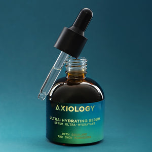 Axiology ultra-hydrating serum bottle with dropper on a teal background