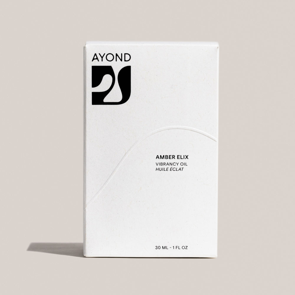 AYOND Amber Elix Vibrancy Oil in a 30 ml glass bottle against a neutral background, showcasing the elegant packaging of this advanced oil-serum elixir designed for enhancing skin radiance.