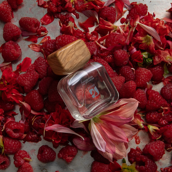 Perfume bottle AYOND Flower Eater Eau De Parfum with wooden cap on raspberries and flowers