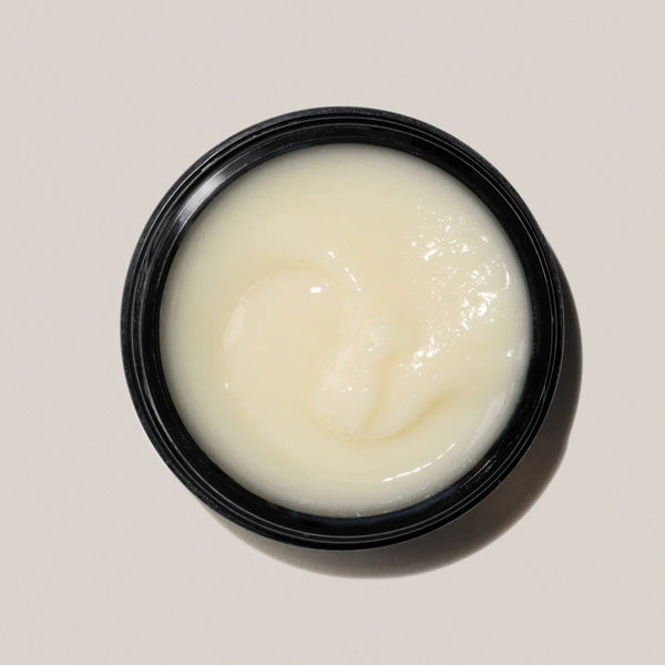 An open black jar of cleansing balm in beige color, this is AYOND Metamorph Cleansing Balm