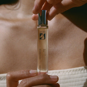 Hand holding AYOND Metamorph Perfume Oil