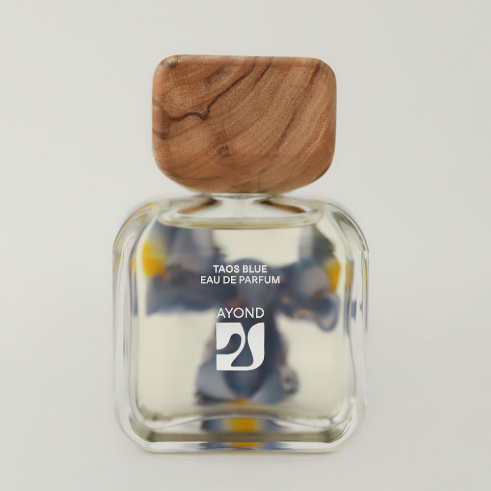 Taos Blue perfume bottle from Ayond with wooden cap on a white background