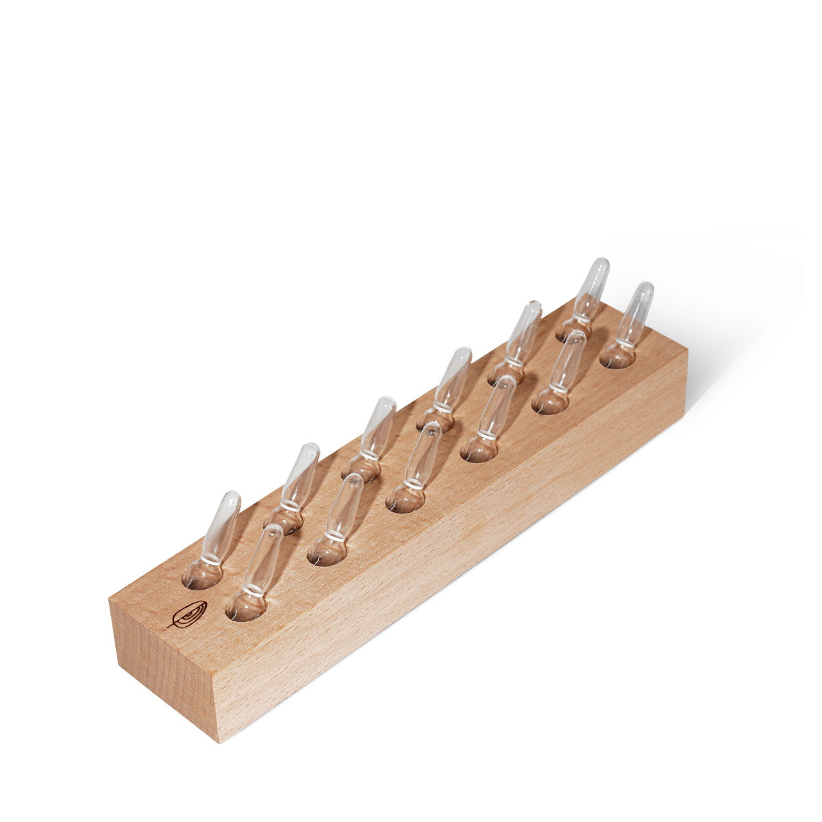 Wooden block with clear ampoules on a white background
