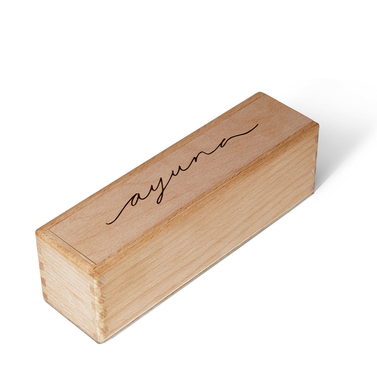 Wooden block with 'ayuna' engraving on a white background