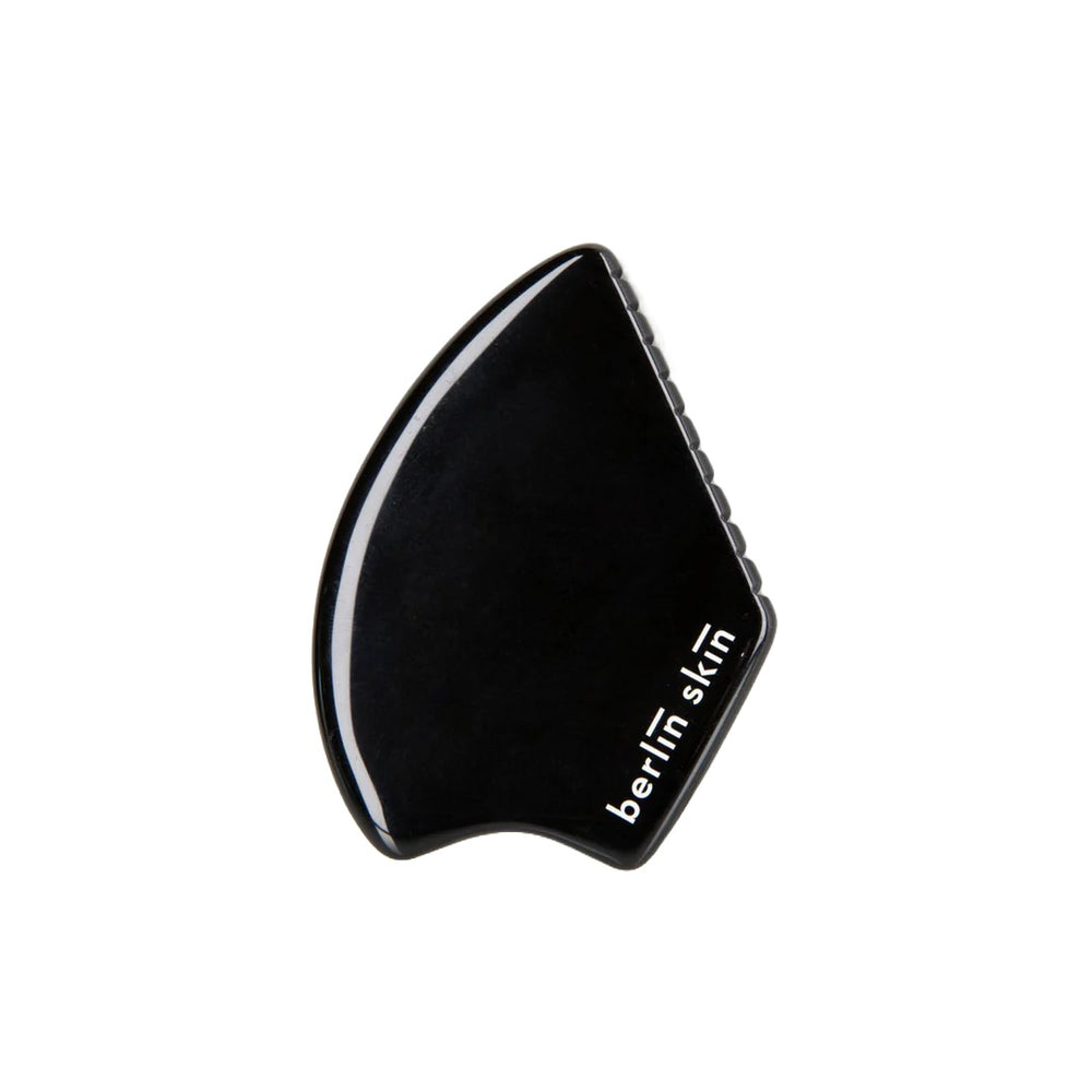 BERLIN SKIN Gua Sha Tool made from black obsidian for a soothing self-care ritual, offering gentle, effective strokes to refresh and smooth the skin.