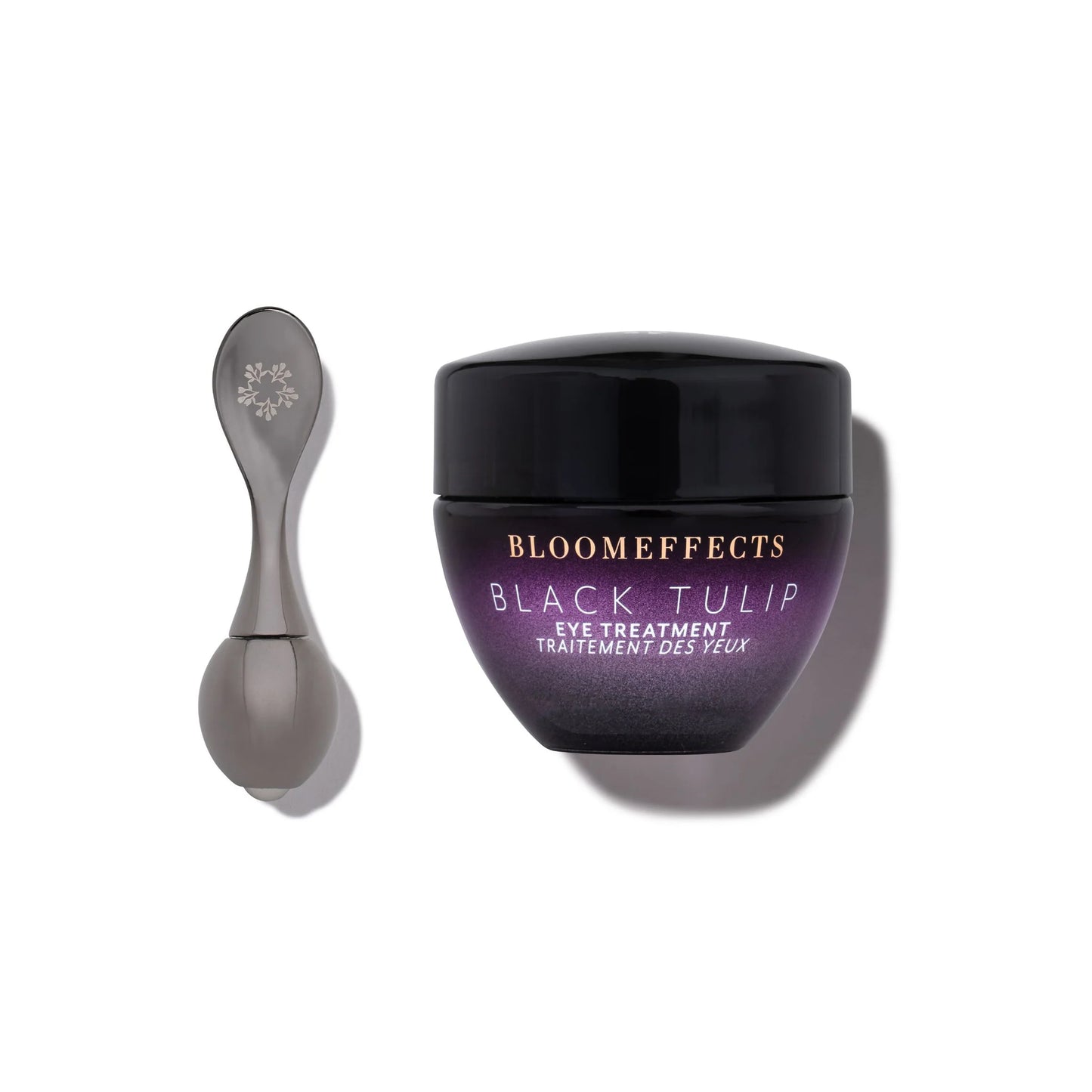 Black Tulip eye treatment jar with applicator on a white background