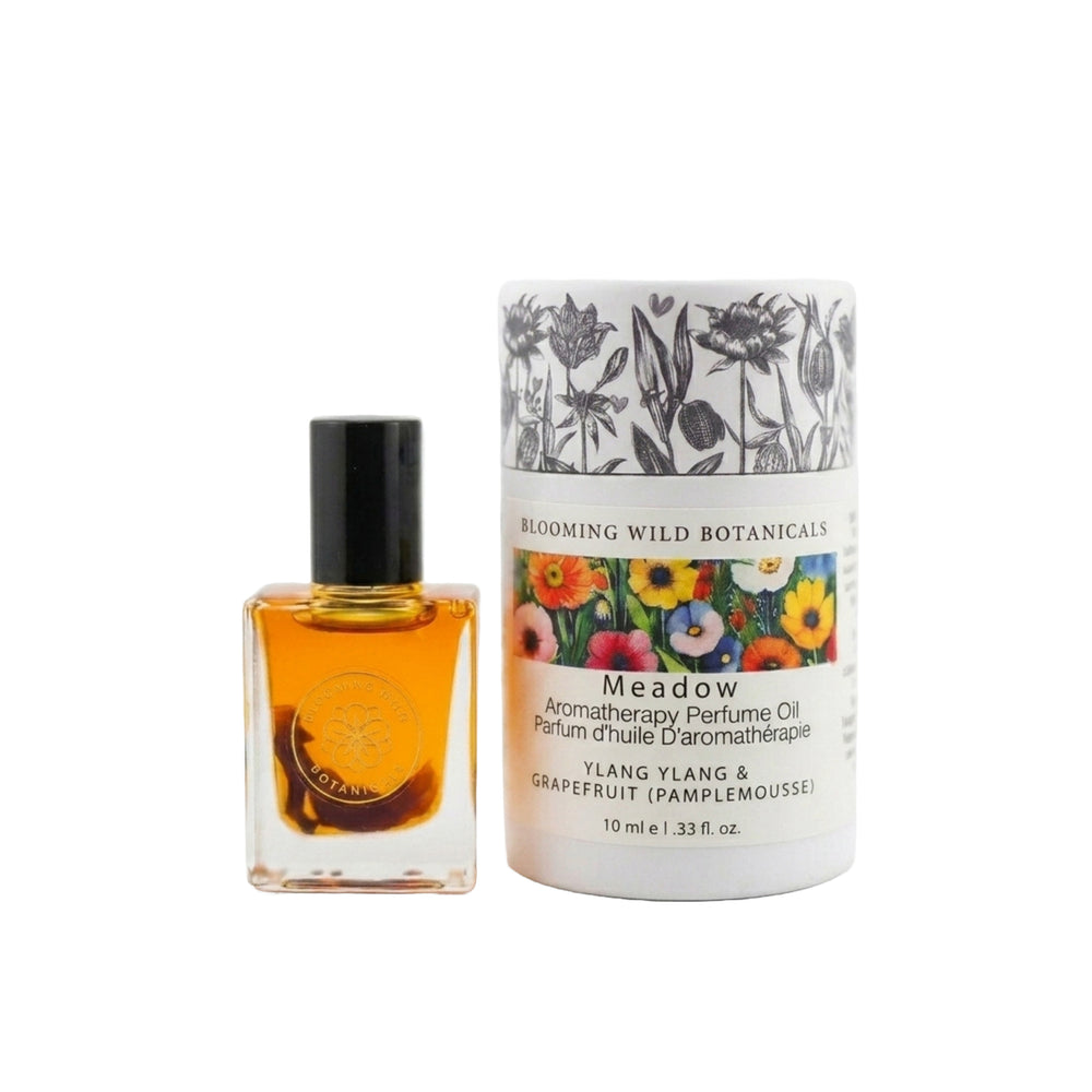 Perfume oil bottle and packaging with floral design on a white background