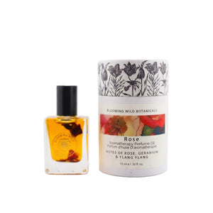 Aromatherapy perfume oil bottle and packaging with floral design on a white background