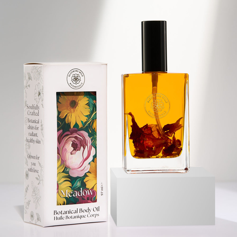 Blooming Wild Meadow Botanical Body Oil bottle filled with golden rosehip-infused oil, scented with ylang-ylang and grapefruit.