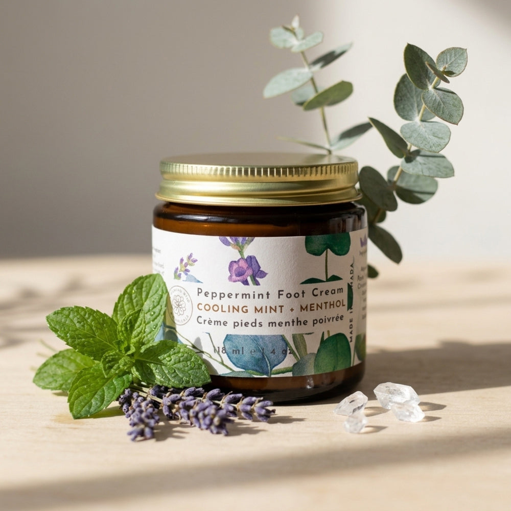 Jar of peppermint foot cream with a gold lid on a white background