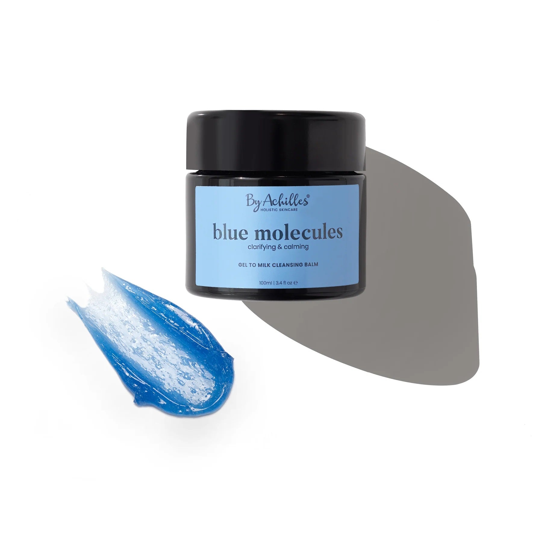 By Achilles Blue Molecules Cleansing Balm in a jar with natural ingredients like Blue Tansy, Yarrow, and Blue Chamomile. Gentle, hydrating oil-to-milk cleanser for soft, balanced skin.