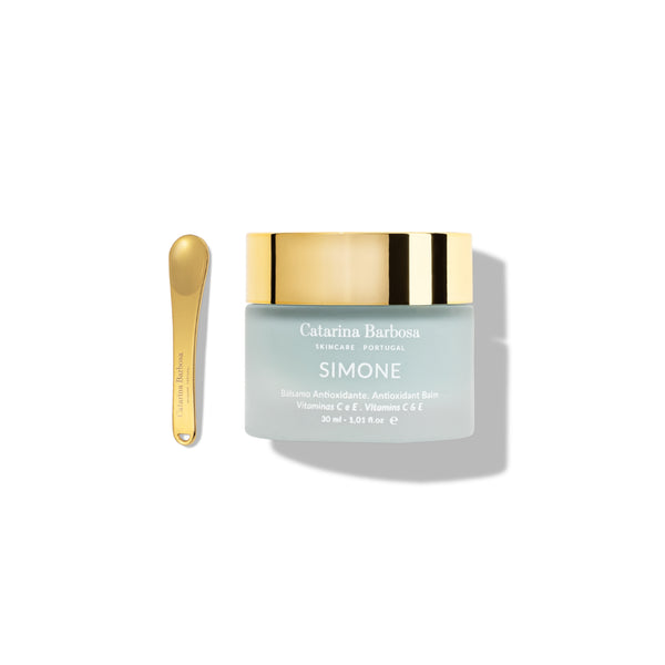 Catarina Barbosa Simone antioxidant balm with a blue-hued color in a jar with gold cap on white background.