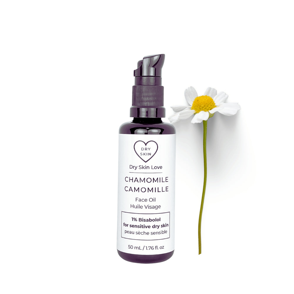 Dry Skin Love Chamomile Face Oil for sensitive skin in a black glass 50ml bottle with white label and black pump, containing organic blue chamomile CO2 extract, bisabolol, rice bran oil, and apple seed oil.