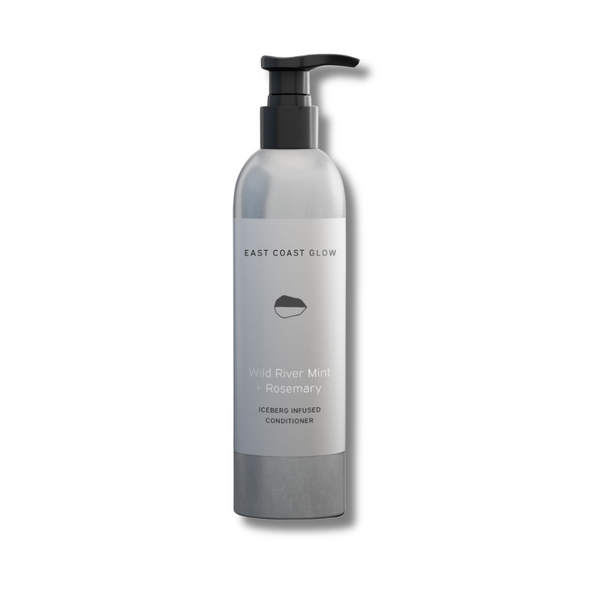 East Coast Glow Wild River Mint + Rosemary Iceberg Infused Hair Conditioner in a bottle, featuring a lightweight, hydrating formula with wildcrafted botanicals for soft, healthy-looking hair.