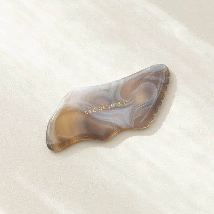 Handcrafted Agate Gua Sha tool with five distinct edges for face sculpting and enhancing skincare absorption.