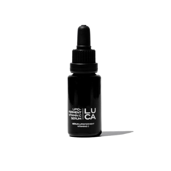  FIFTY7KIND LUCA Lipid Ferment Vitamin C Serum in a Miron Glass bottle with a handcrafted heart, featuring a potent blend of Vitamin C, Astaxanthin, and plant-based extracts for skin hydration and protection.