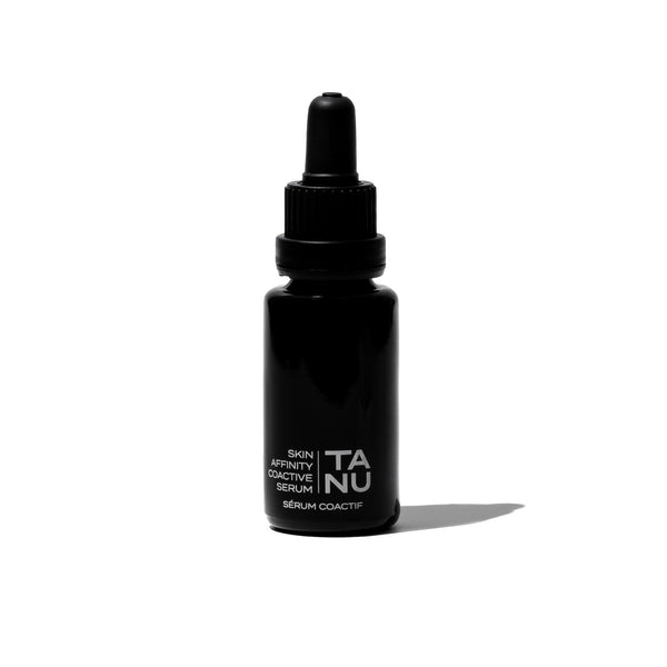 FIFTY7KIND TANU Skin Affinity Coactive Serum in a violet glass bottle, featuring a golden-hued formula with potent botanical ingredients.