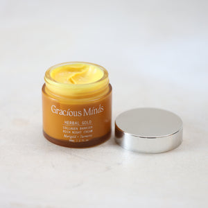 glass jar of Gracious Minds Herbal Gold cream on a white background