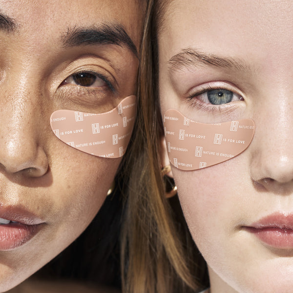 Two women wearing under-eye patches from H is for Love.