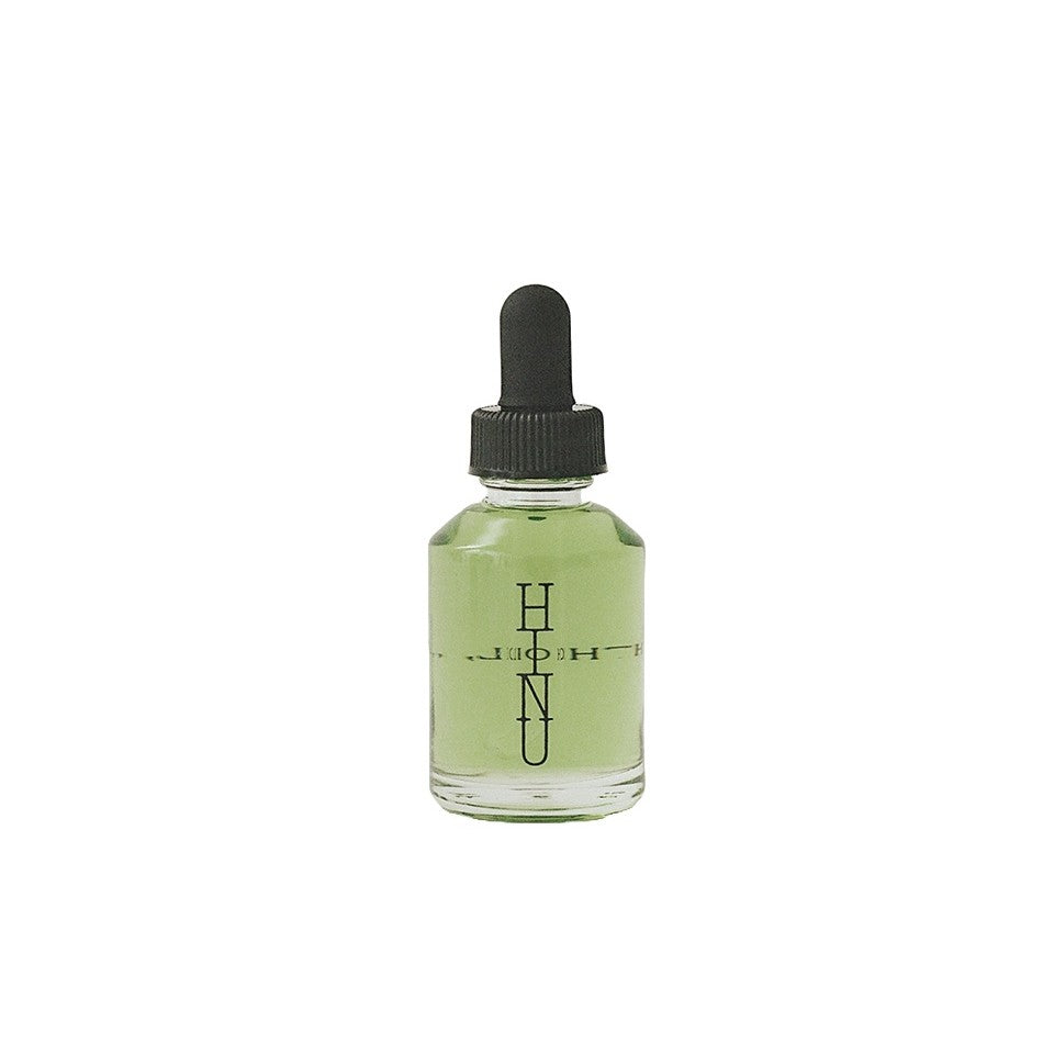 A bottle of HINU Hair Growth Oil — a natural, lightweight oil blend for supporting healthy, conditioned hair from scalp to ends. 30ml