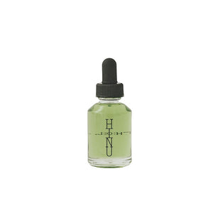 A bottle of HINU Hair Growth Oil — a natural, lightweight oil blend for supporting healthy, conditioned hair from scalp to ends. 30ml