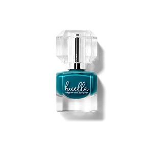 Huella Anchored to You nail lacquer in a deep teal blue shade, featuring a 15-free, vegan, and chip-resistant formula.